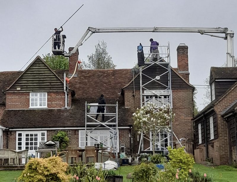 The Roof Moss Cleaners using cherry picker and scaffolding to clean roof safely and professionally in Abbots Langley, Hertfordshire