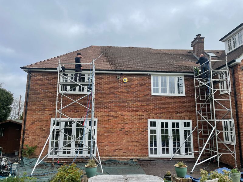 Roof cleaning carried out safely from scaffold towers by The Roof Moss Cleaners in Abbots Langley